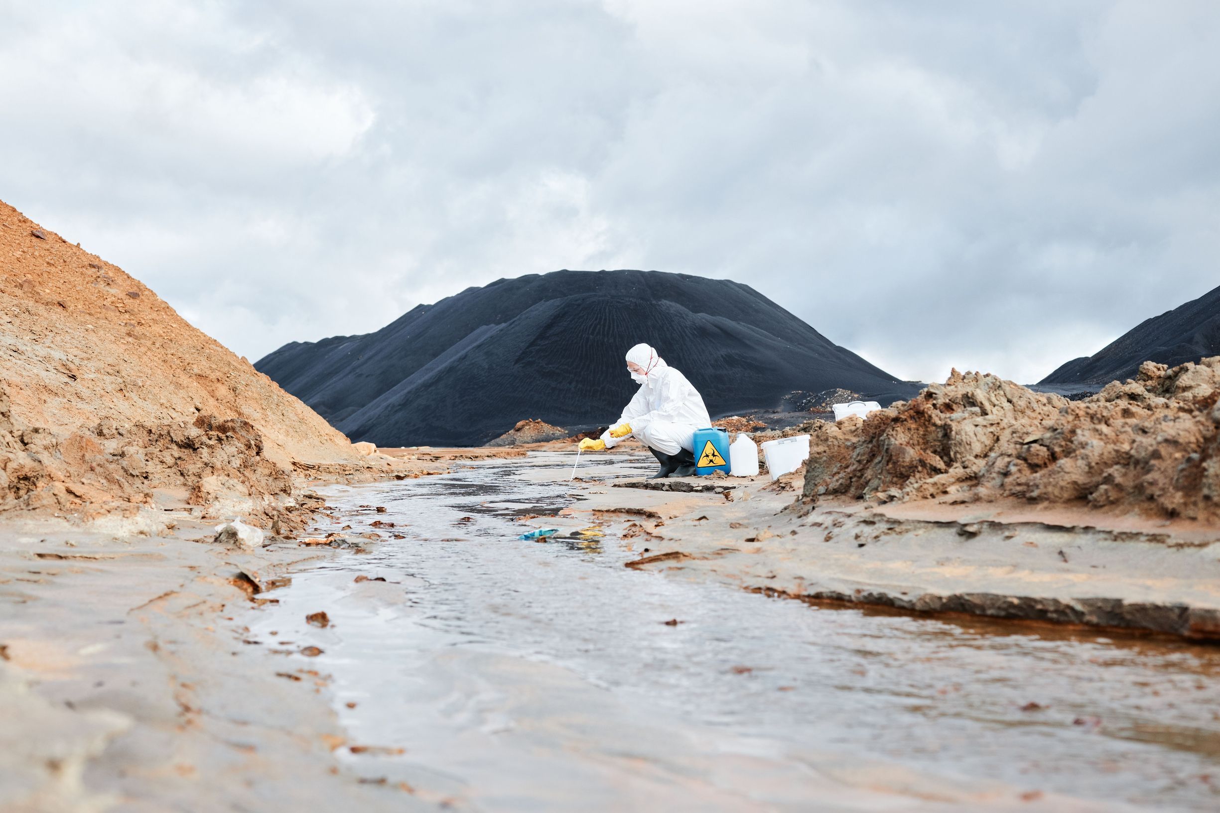 Ecologist retrieves water sample.