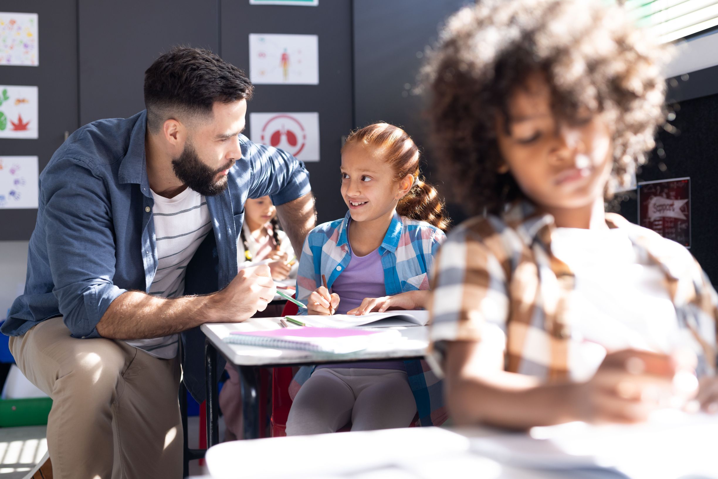 Teacher and student at desk